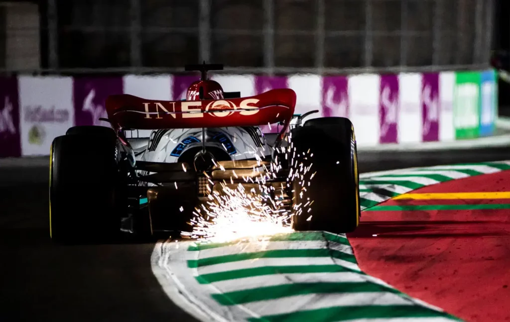 Why do F1 cars spark more on the straights?